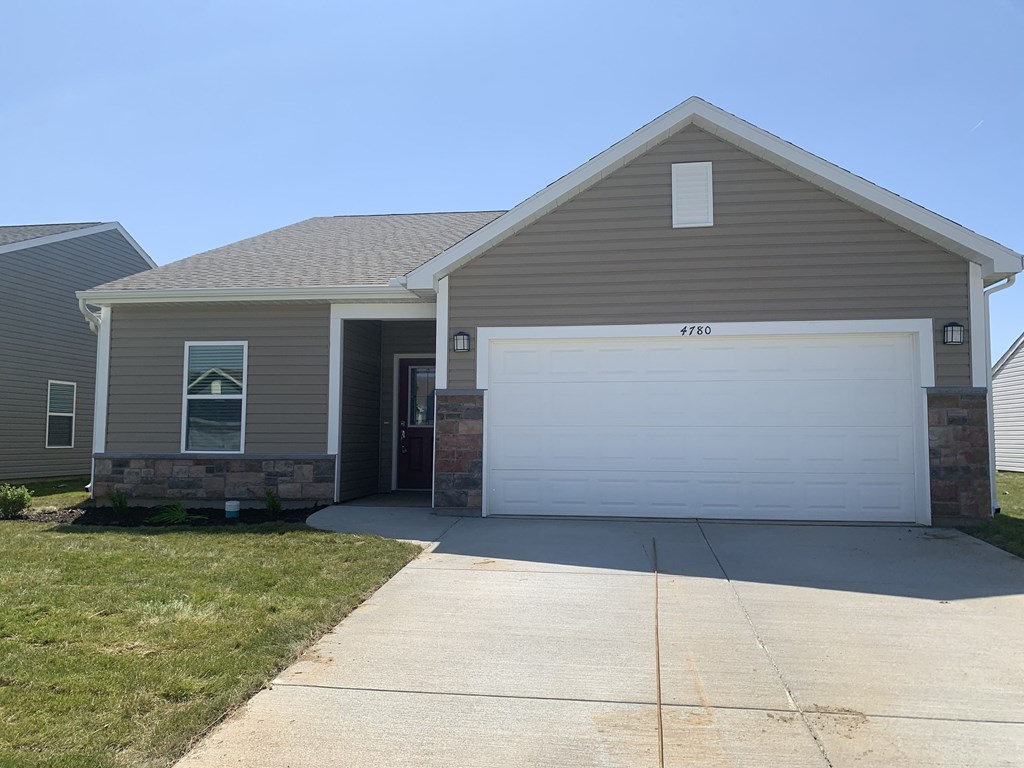 a brown house with a white garage door